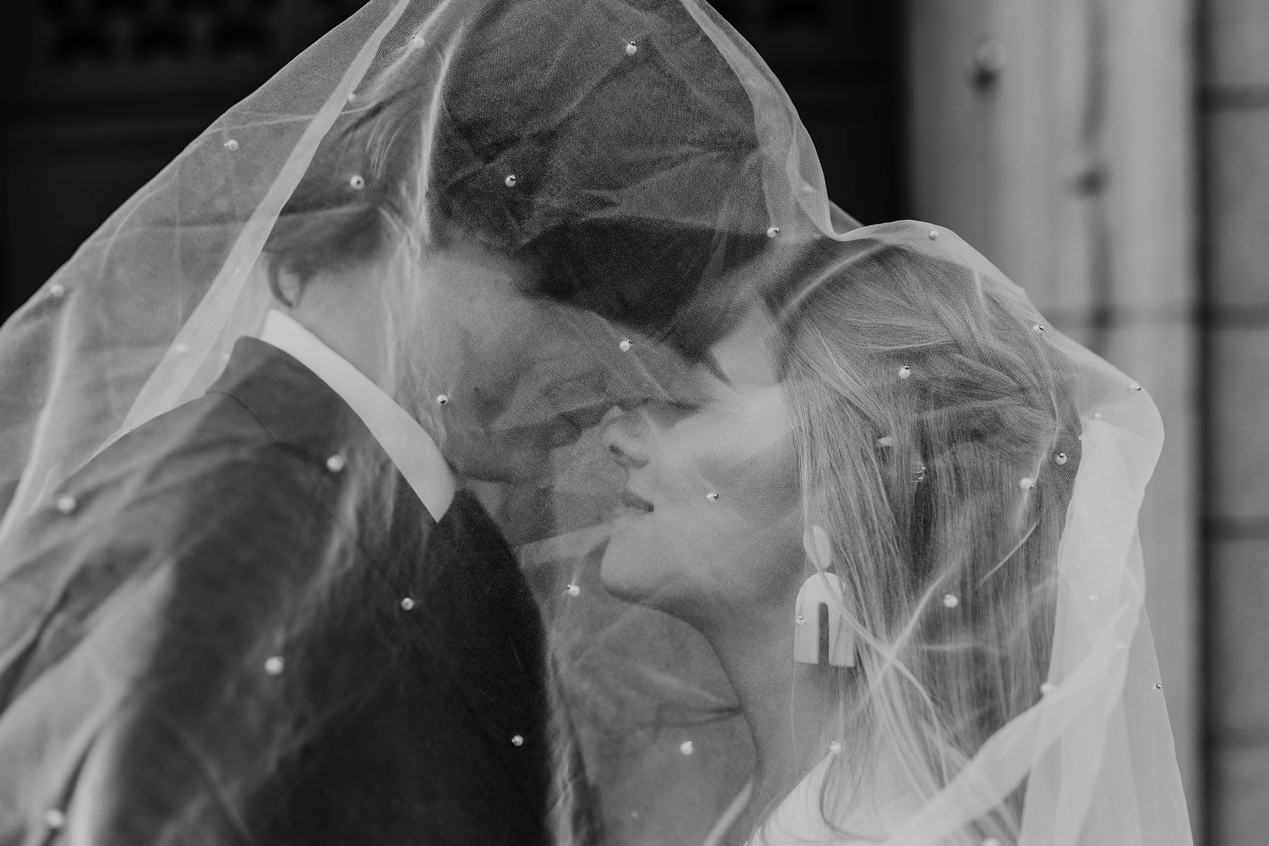 Wedding & Elopement Photographer, a bride and groom tenderly meet nose to nose, beneath her wedding veil