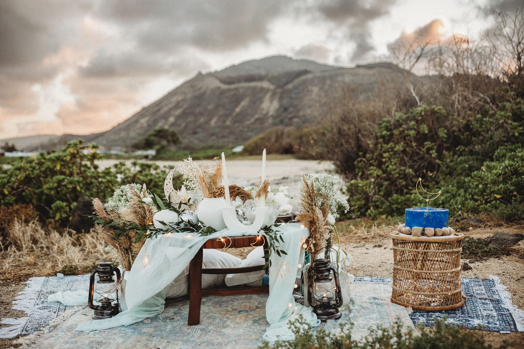 Wedding & Elopement Photographer, a festive table is displayed in the outdoors with floral arrangements