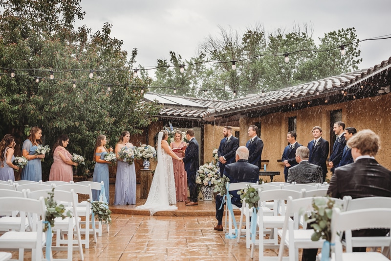Wedding and Photographer, a wedding ceremony is underway despite the exposed rain in a tuscan style venue