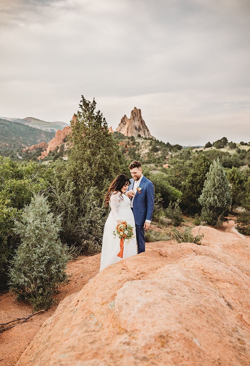 Wedding and Elopement Photography, bride and groom stand together outside in wild dry environment with vegetation