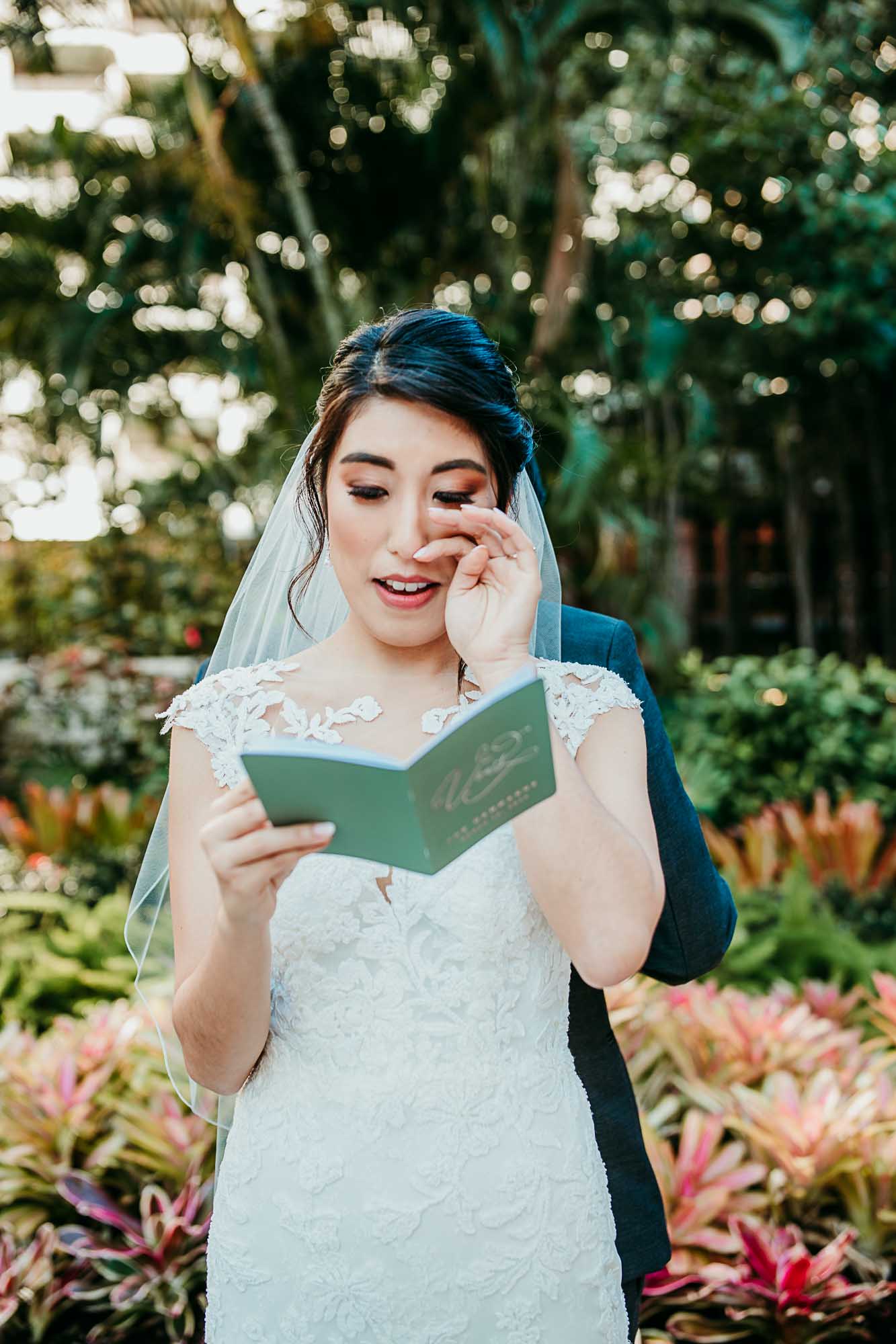 Wedding & Elopement Photographer, a bride happily tears up as she reads vows