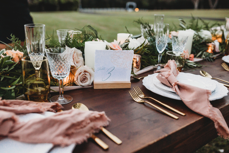 Wedding and Photographer, a beautifully set wedding table is full with floral arrangements