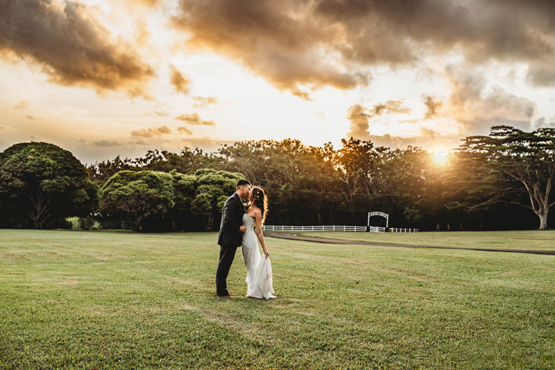Wedding and Elopement Photography, bride and groom kiss on a freshly mowed grass field on a ranch