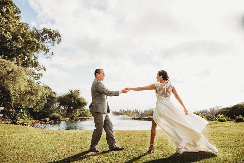 Wedding and Photographer, bride and groom dance on the grass before a lake