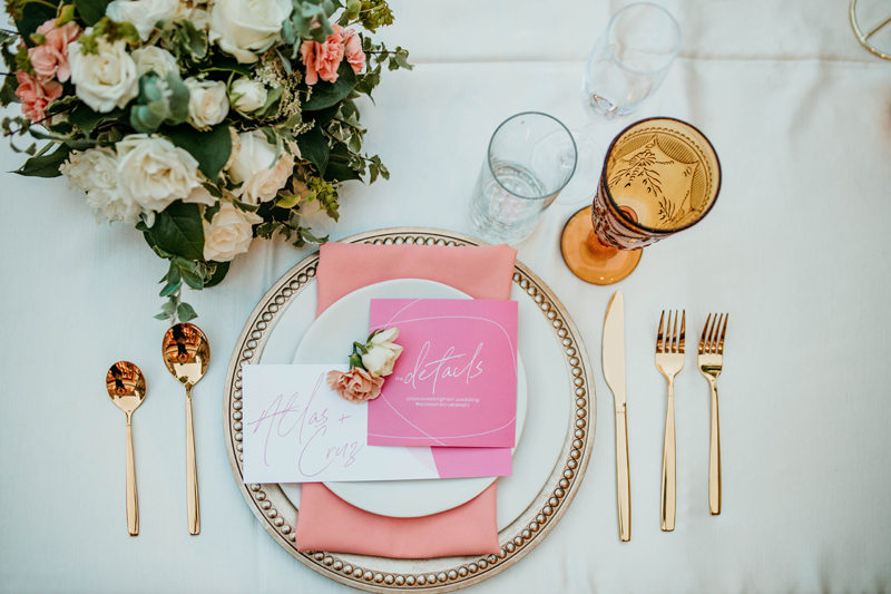 Wedding and Photographer, a wedding place setting sits beside a floral bouquet