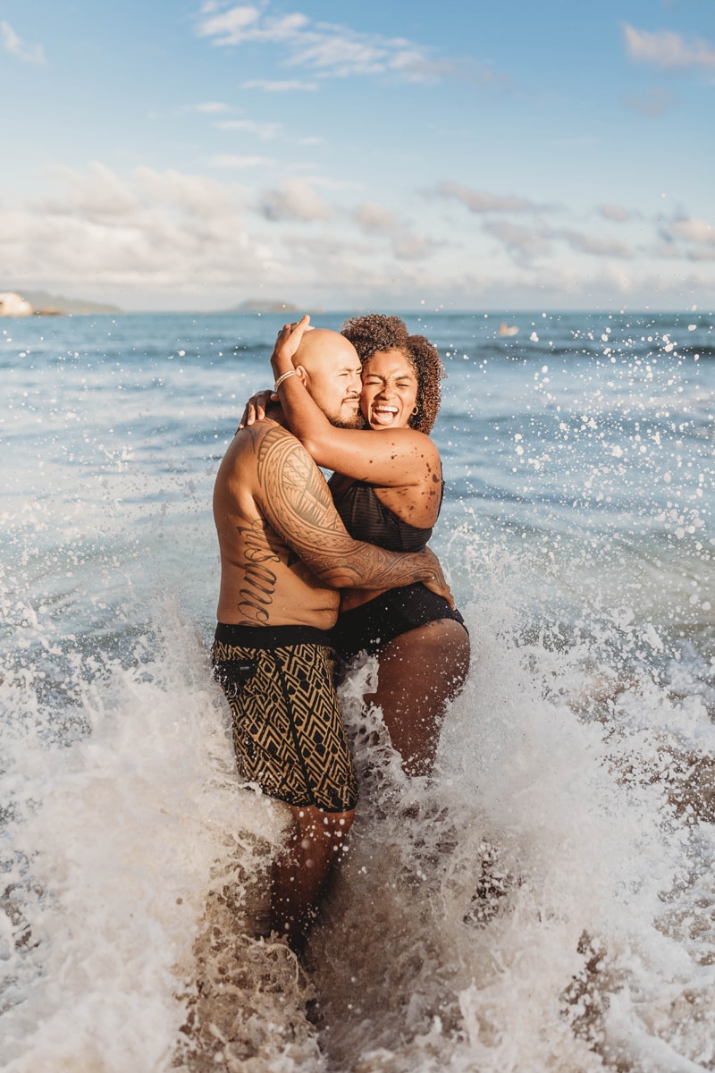 Wedding & Elopement Photographer, couple standing in waves at the beach