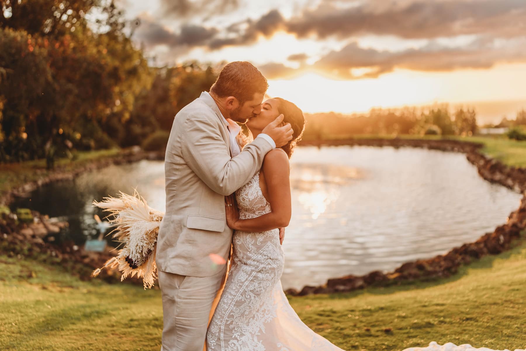 How To Elope In Hawaii, bride and groom kissing during sunset