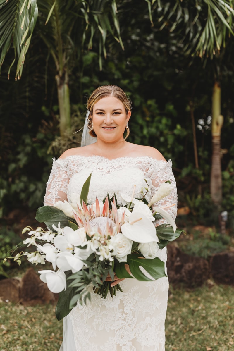 Wedding Photographer, bride standing holding a large white bouquet