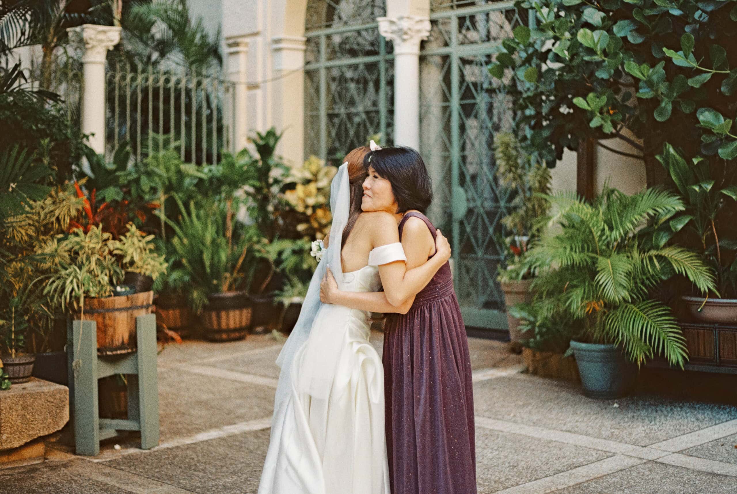 A bride hugging a wedding guest