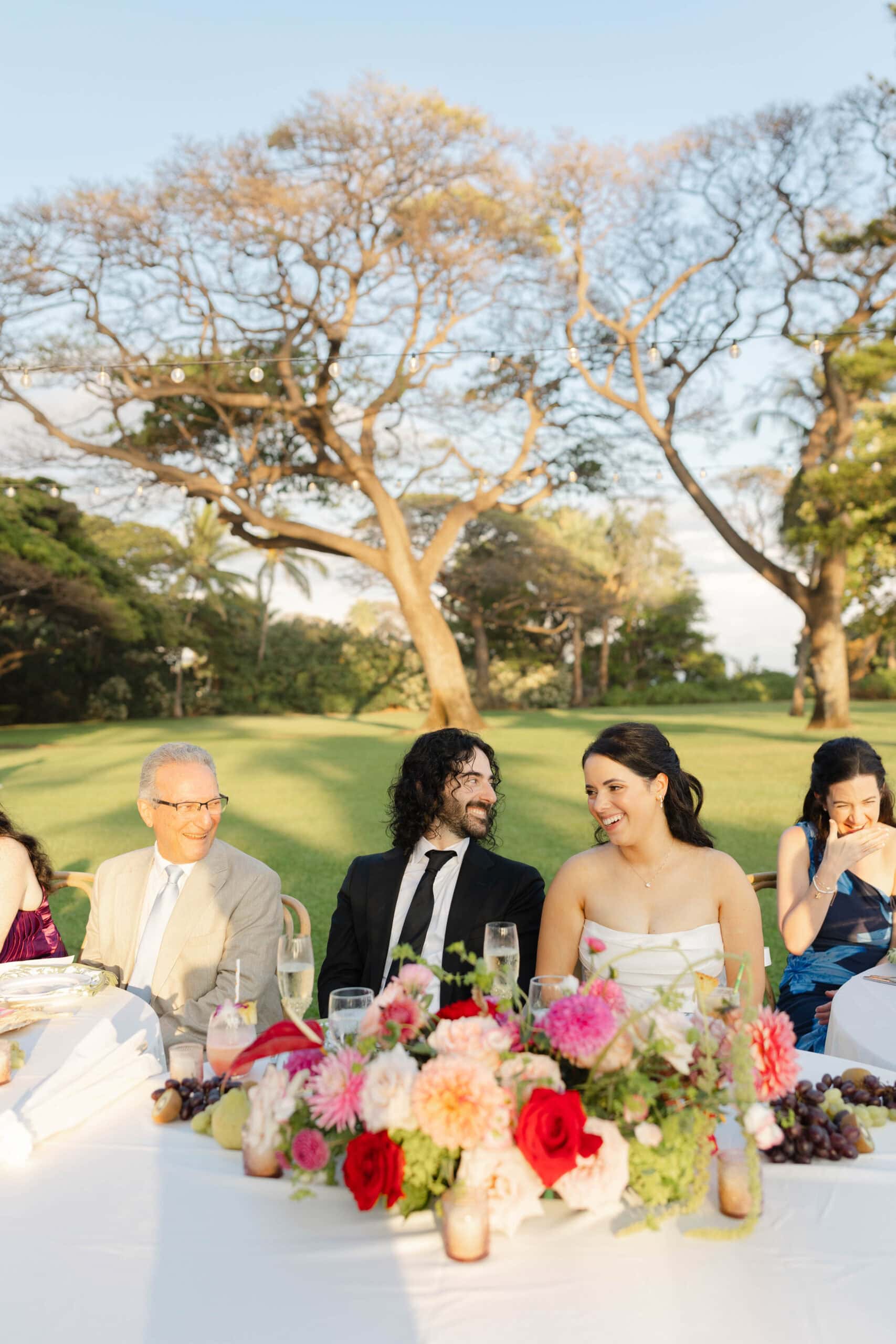 A bride and groom laughing during their wedding reception