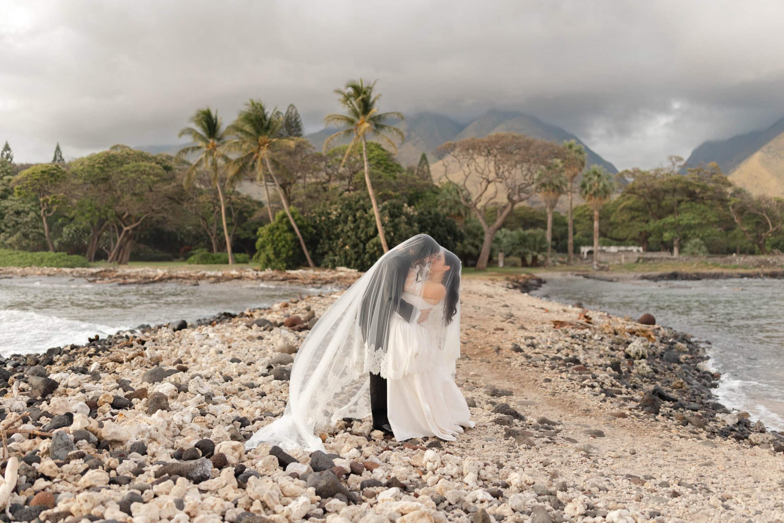 A bride and groom taking beach wedding photos