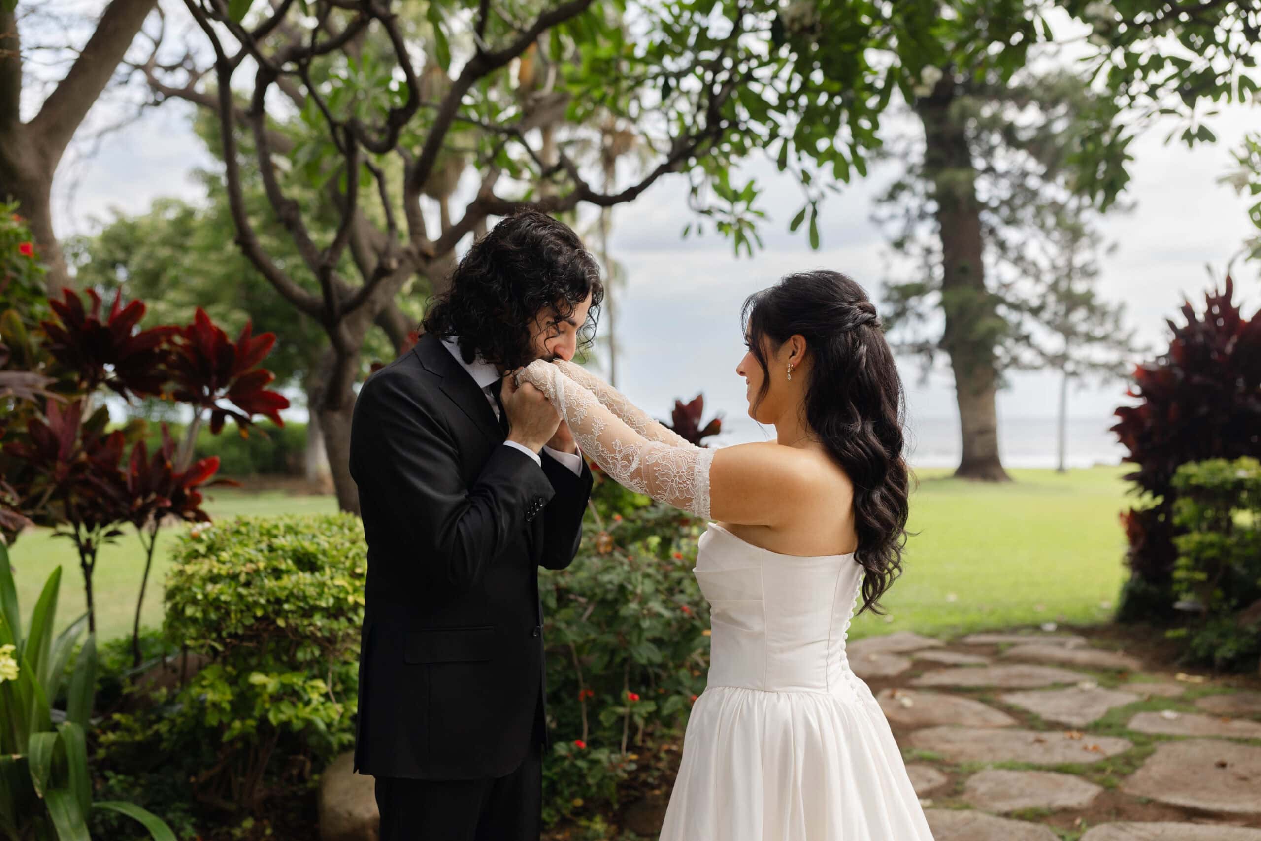 A bride and groom posing for wedding photos during their first look