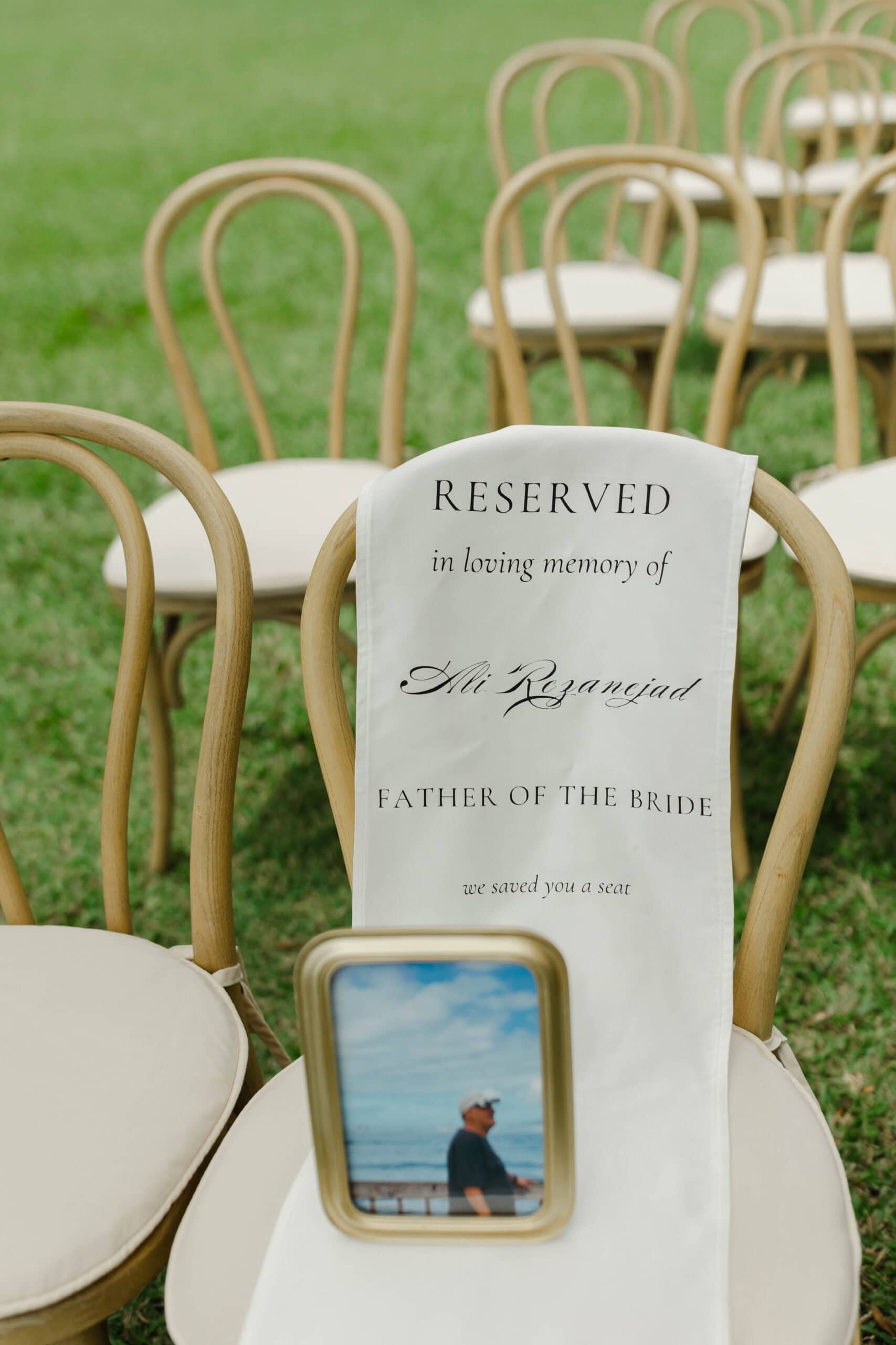 A reserved in memory of wedding chair at a ceremony