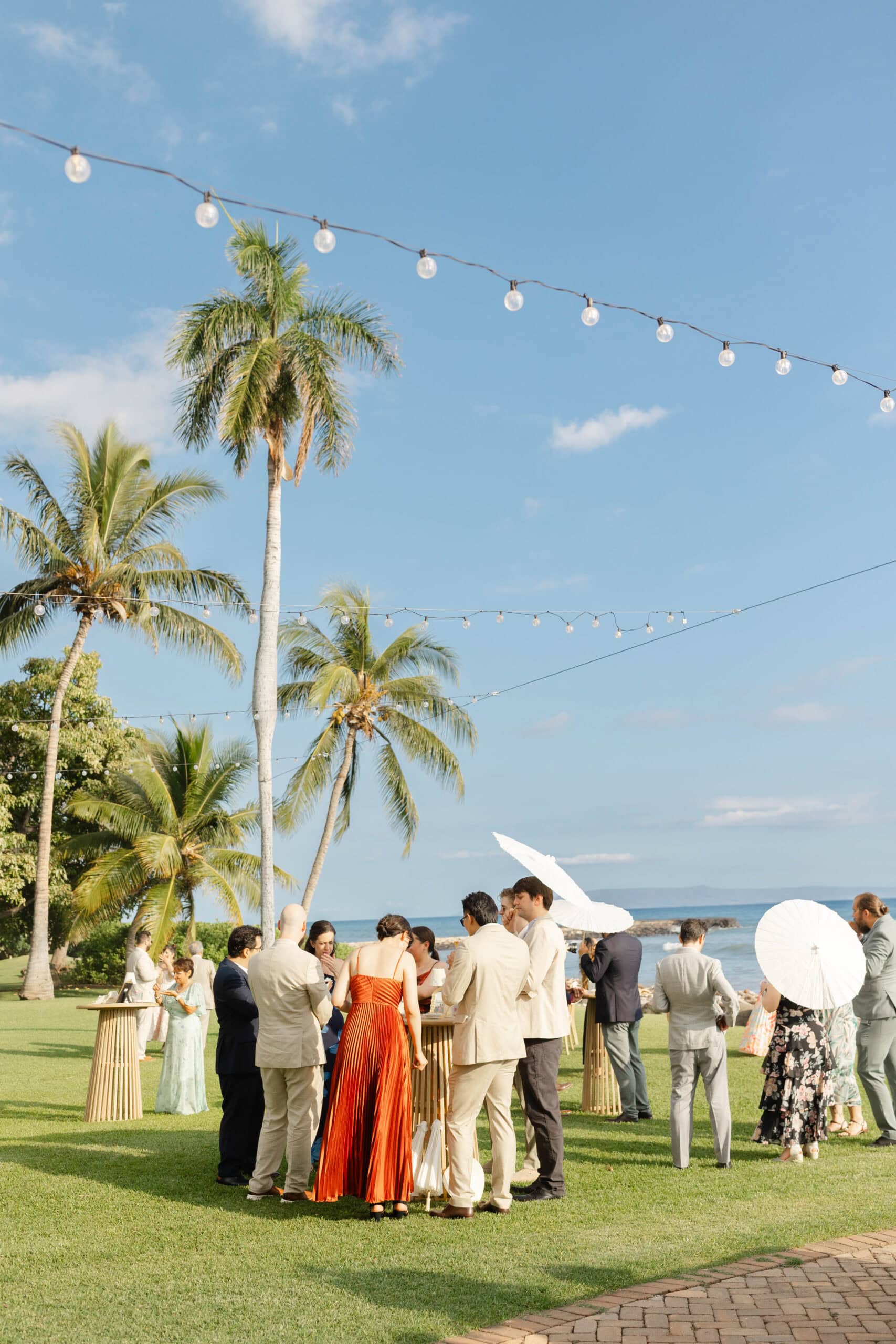 Wedding guests at a cocktail hour at Olowalu Plantation House