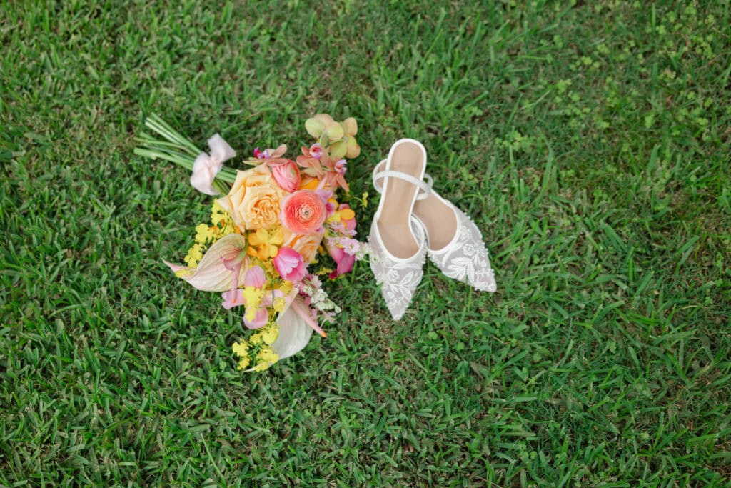 A wedding flat lay with shoes and a bouquet