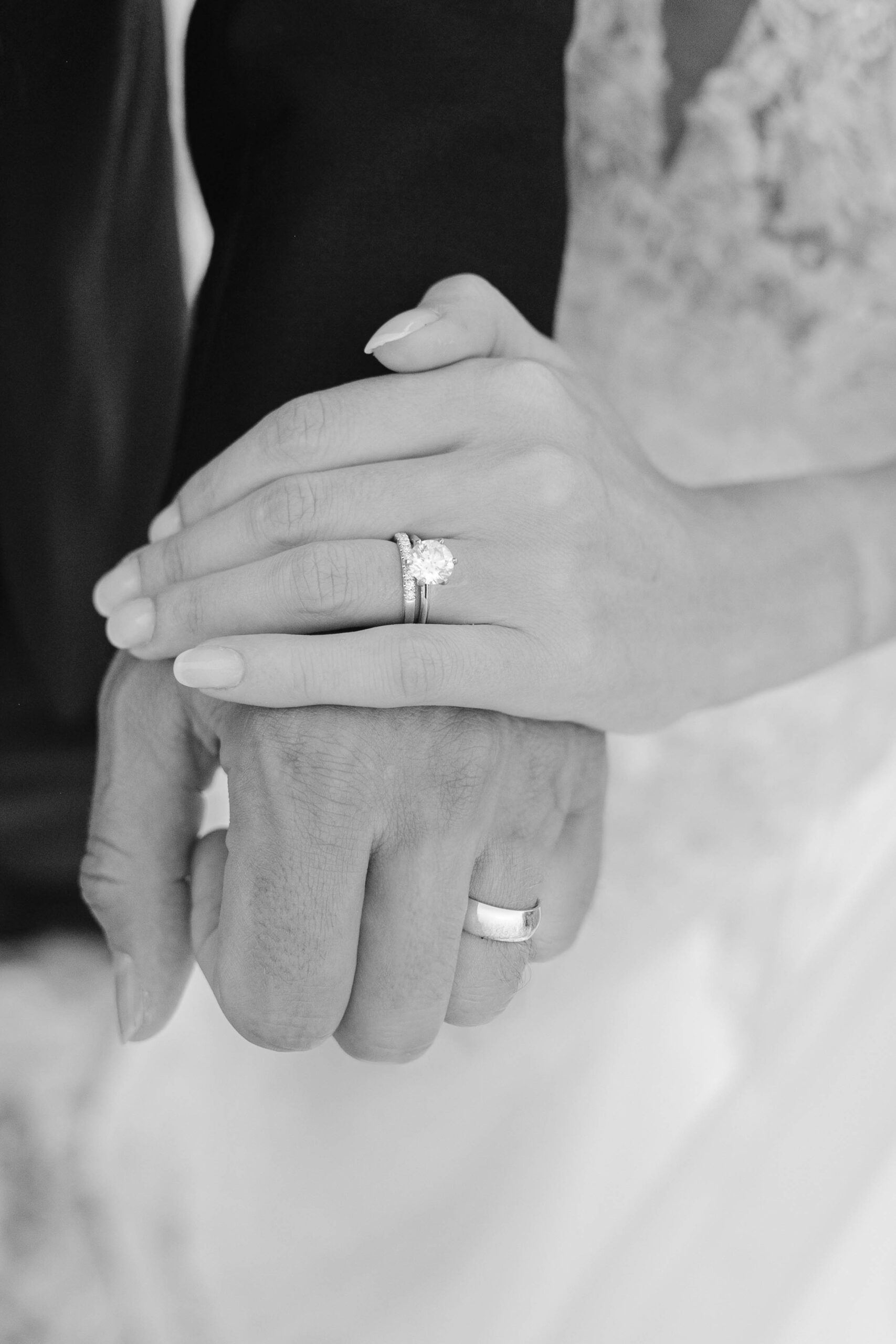 A couple holding hands in their wedding photos