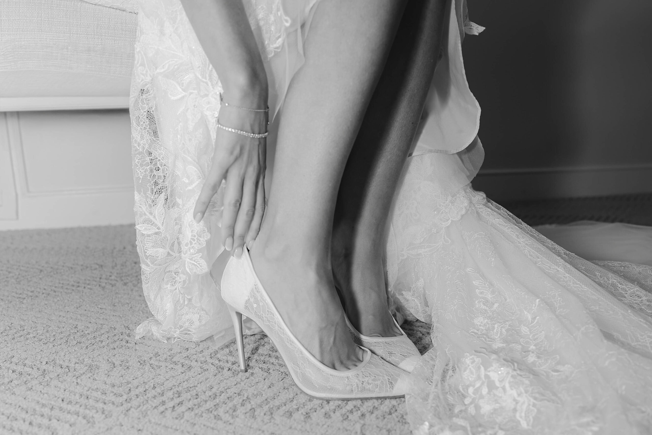A bride putting on her wedding shoes