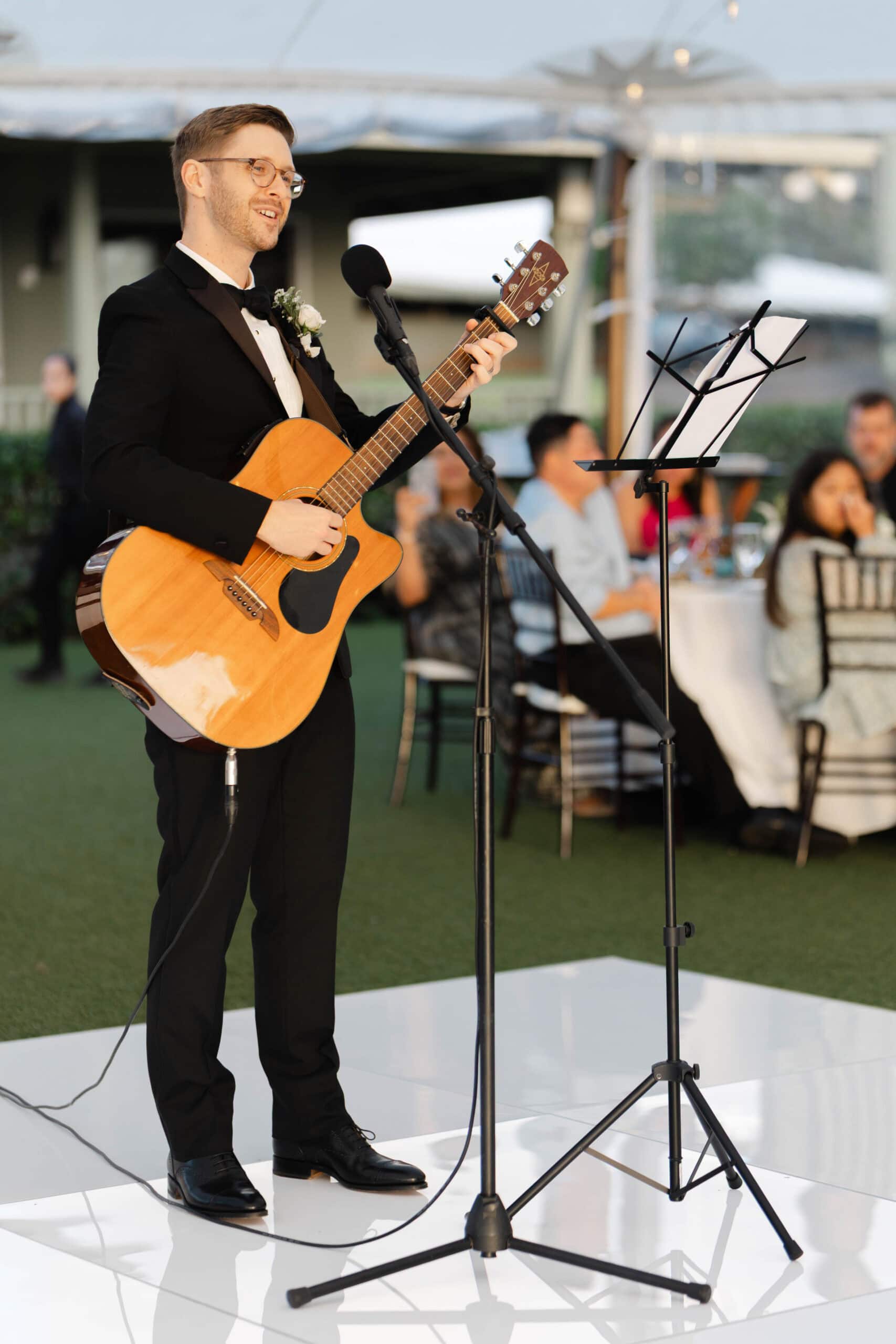A groom singing at a wedding reception