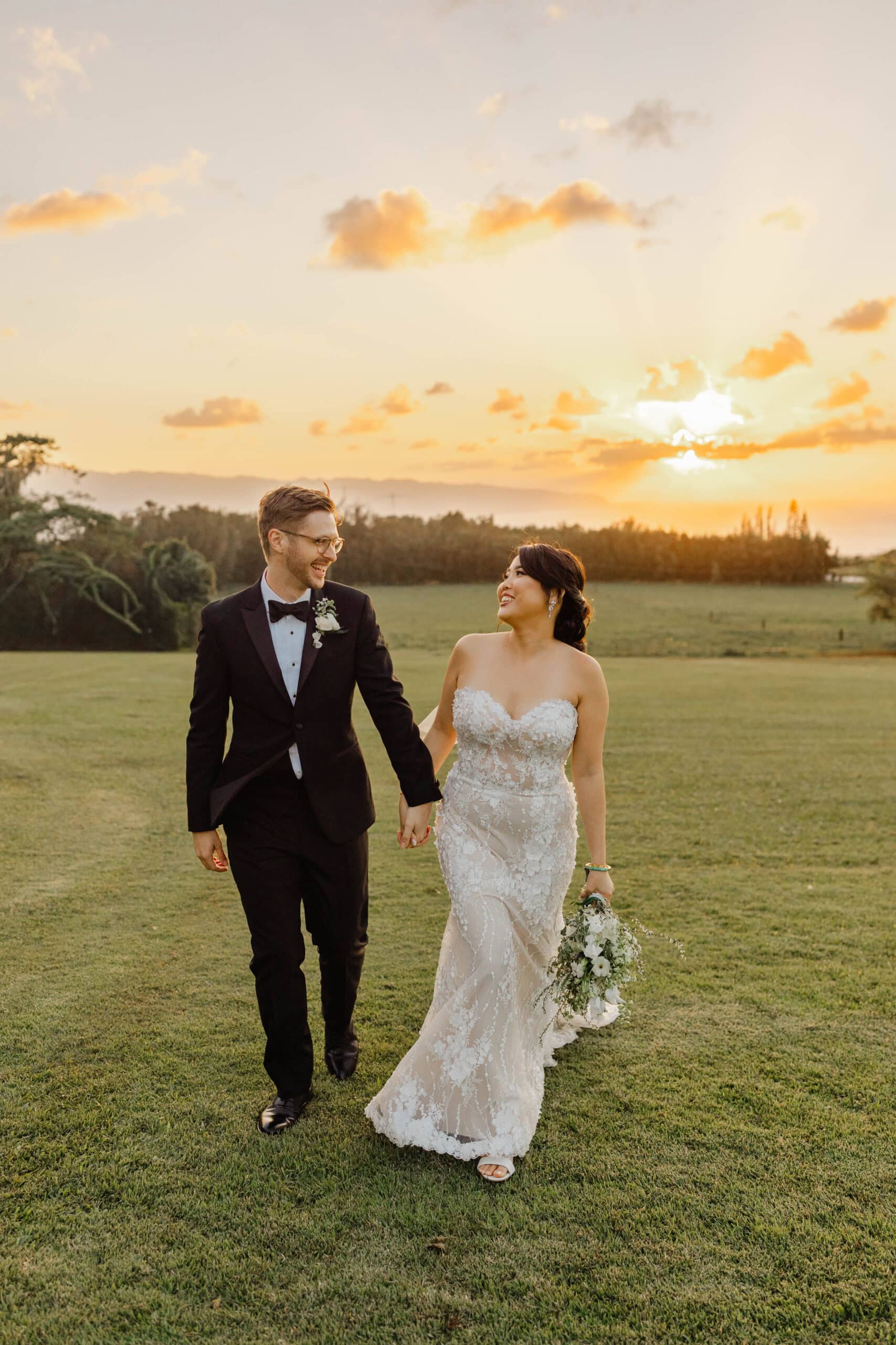 A bride and groom taking sunset wedding photos